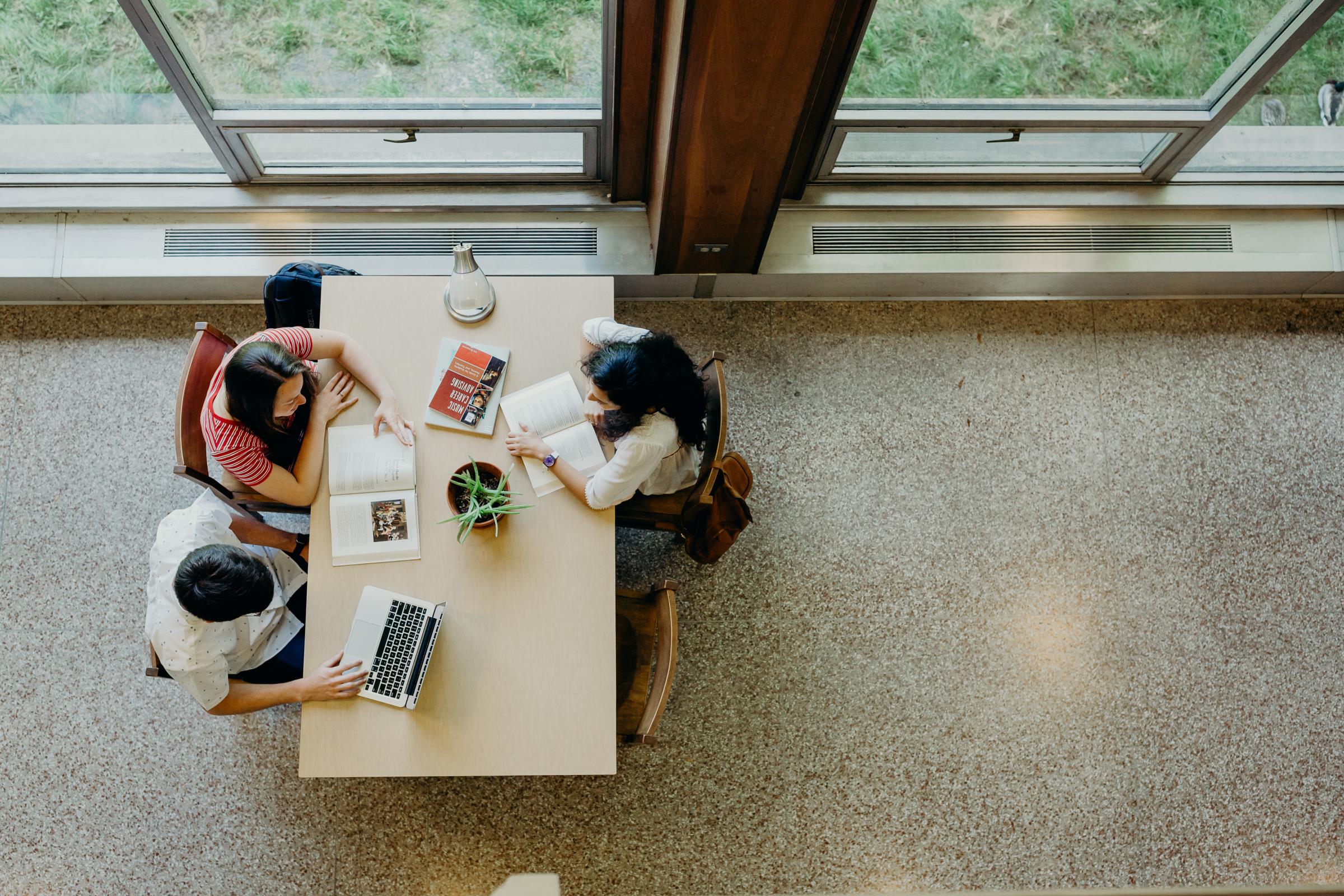 Students sitting together and discussing homework